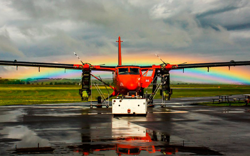 DHC-6-300 in front of rainbow